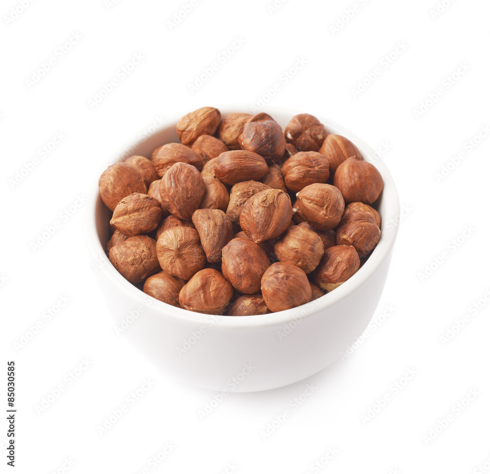 Cup filled with the hazelnuts isolated Cup filled with the hazelnuts isolated