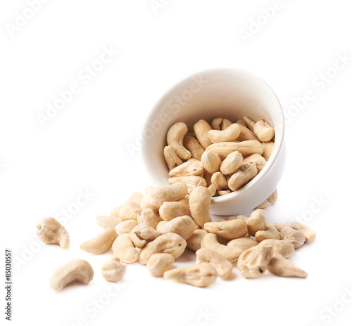 Cup filled with the cashew nuts isolated photo