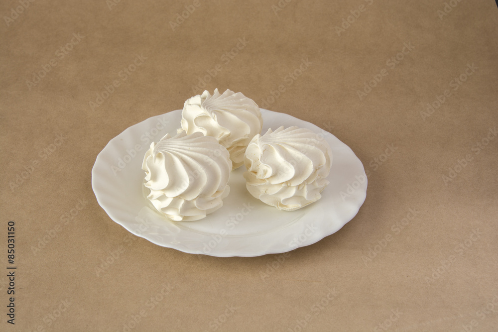 Vanilla marshmallows on a white dish Vanilla marshmallows on a white dish