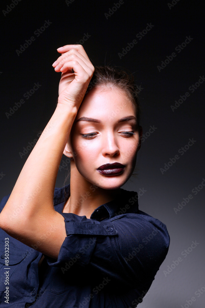 Portrait of beautiful young woman face. Isolated on black