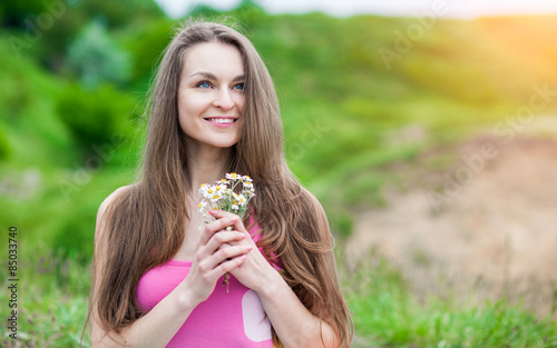 Romantic Young Woman outdoors at a summer day.