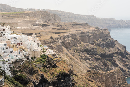 Fira in Santorini, seen from the edge of the cliffs, with a view of the Caldera in the background.