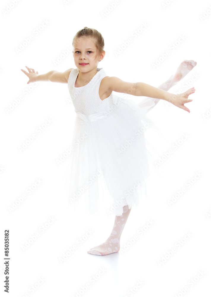 Stylish blonde girl in a white ballet dress makes swallow Stylish blonde girl in a white ballet dress makes swallow