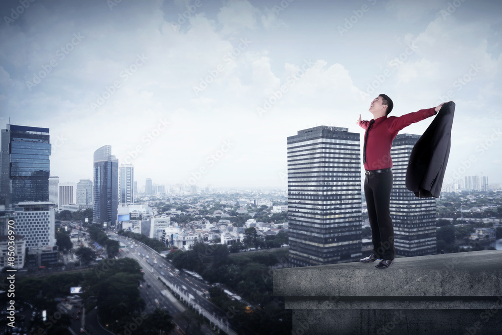 Happy businessman standing on the rooftop Happy businessman standing on the rooftop