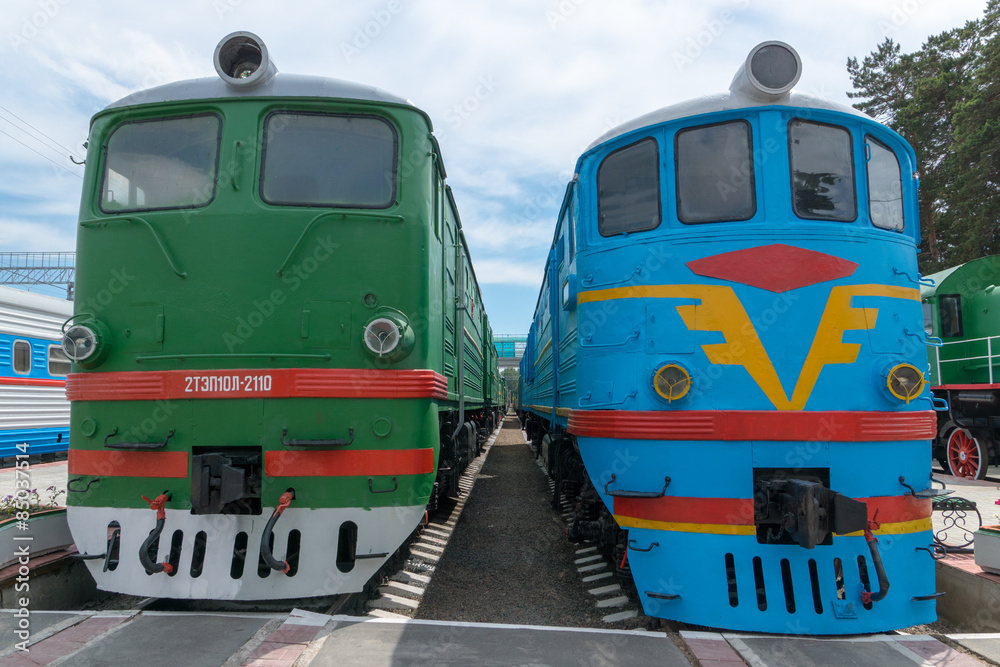 green and blue trains at station green and blue trains at station
