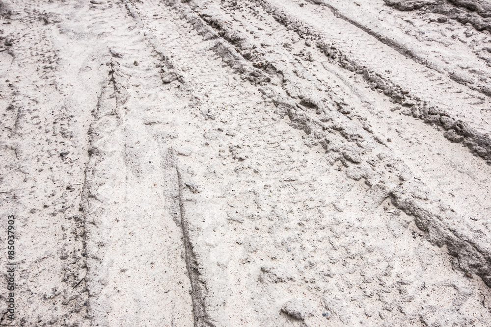 Dirty grunge tyre track on wet sand texture Dirty grunge tyre track on wet sand texture