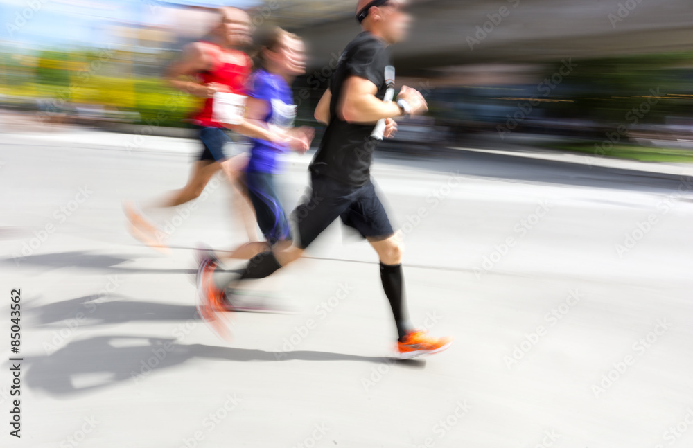 Three men in running competition