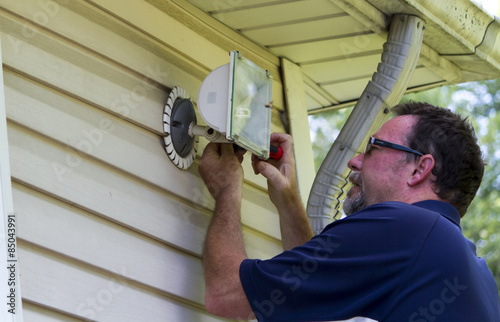 Electrician Working On A Outside Light