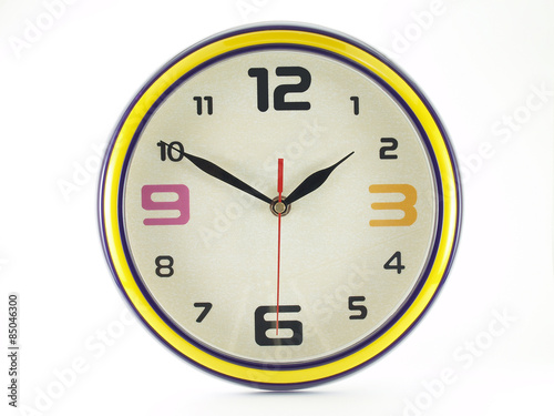 colorful round shaped wall clock with yellow edge isolated on white background, clock hands shown ten minutes to two o'clock