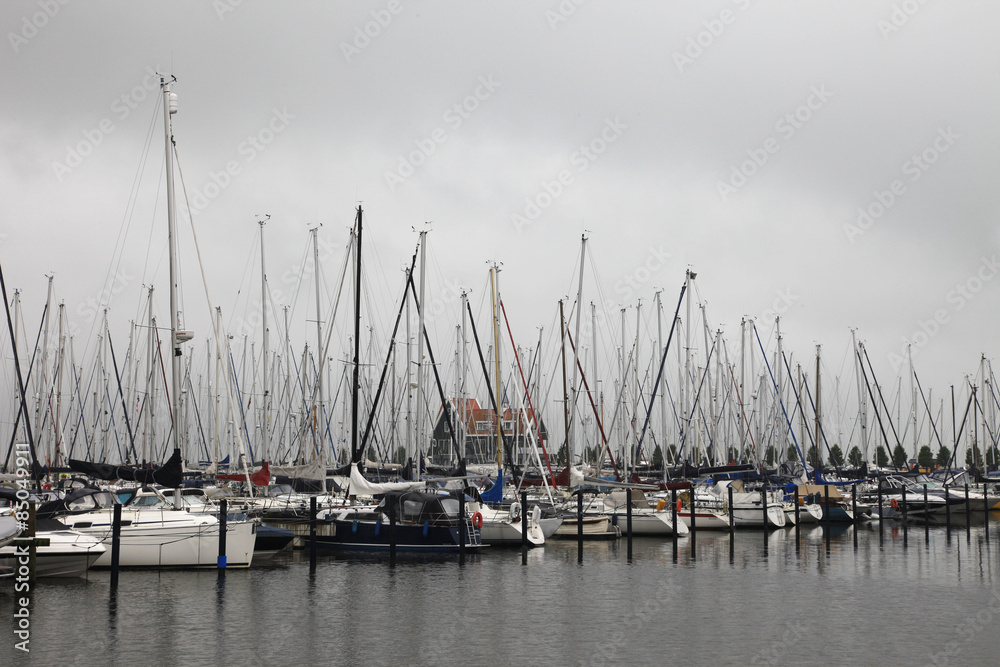 Boats in harbor during bad weather.