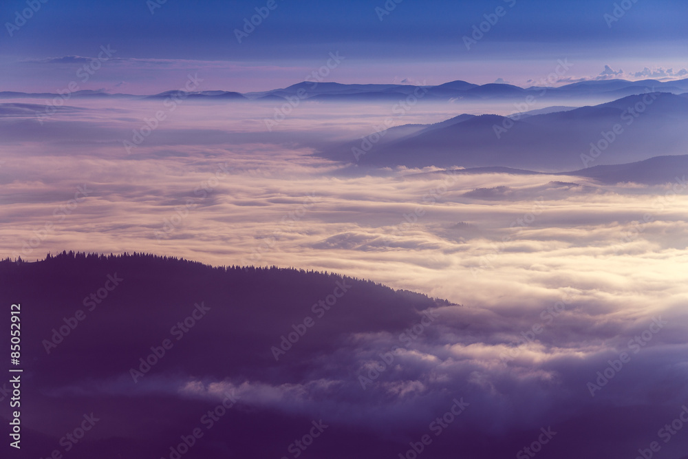 Colorful  sunrise in the mountains.Fog in the valley.