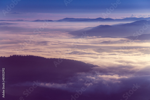 Colorful sunrise in the mountains.Fog in the valley.