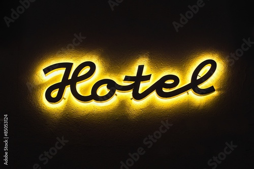 Photography Illuminated hotel sign on the building