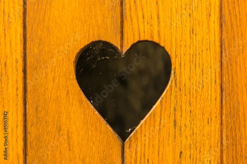 Old wooden door with heart decoration
