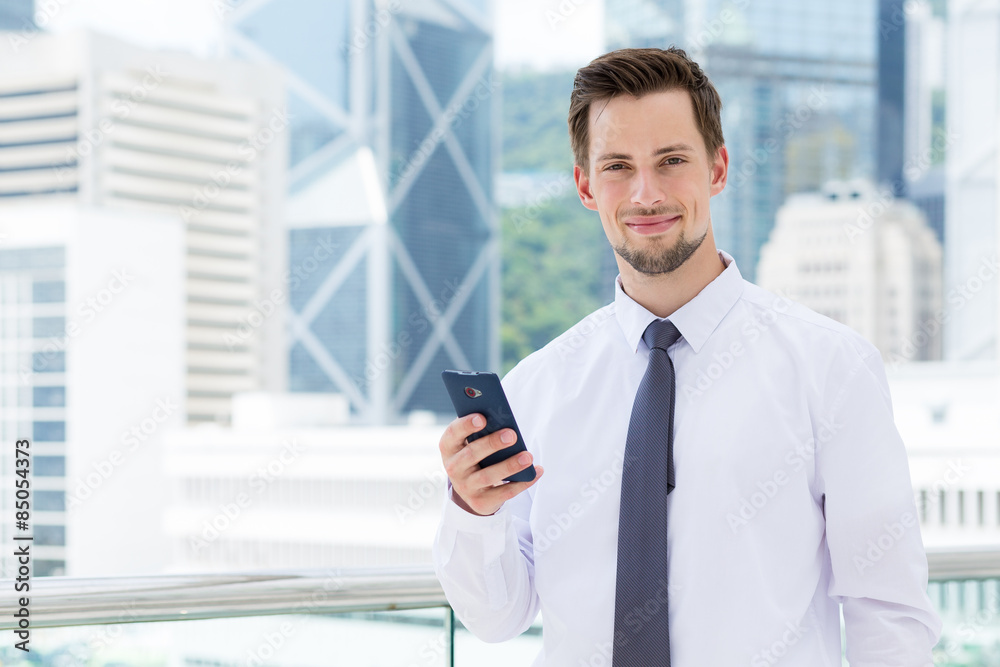 Young businessman use of the smartphone at outdoor Young businessman use of the smartphone at outdoor