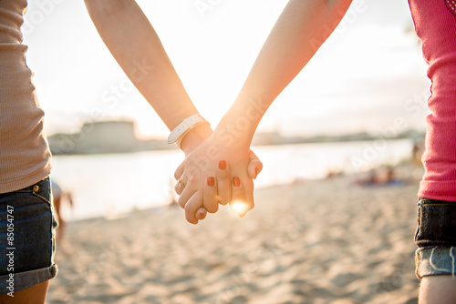 Girl holding hands on the beach
