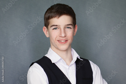 Фотография Portrait of happy schoolboy teenager