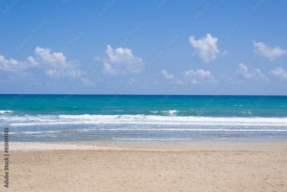 Empty, sunny beach with blue sky