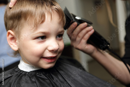 Smiling child at the barbershop
