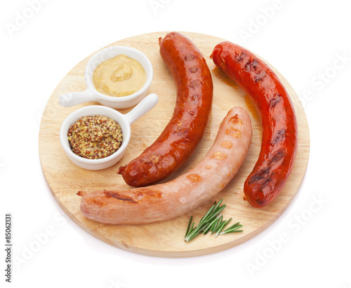 Various grilled sausages with condiments