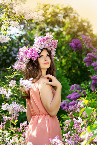 Portrait of a beautiful girl in pink with flowers