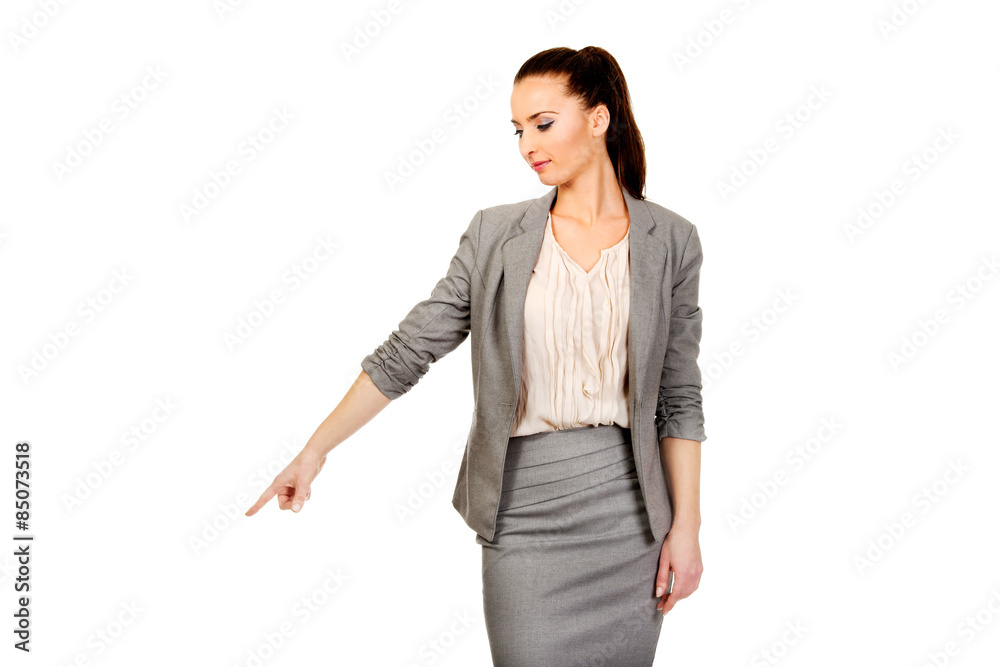 Businesswoman pointing down. Businesswoman pointing down.