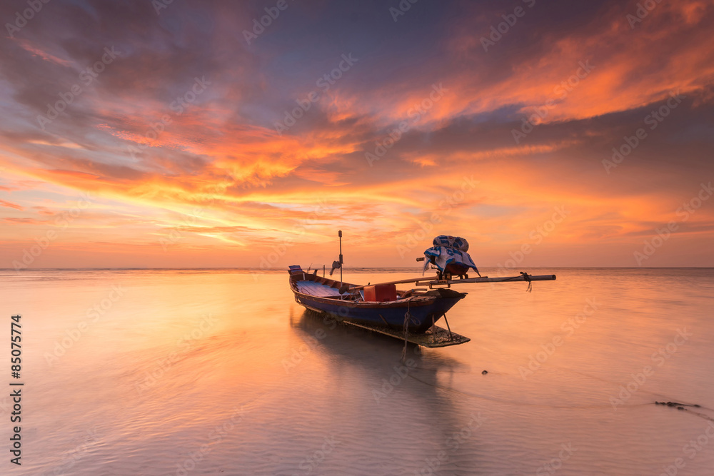 Traditional thai boats at the sea with beautiful sunset