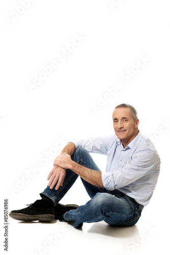 Mature man sitting on the floor © Piotr Marcinski