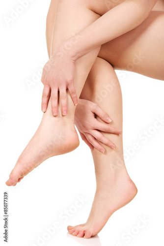 Woman massaging her legs.
