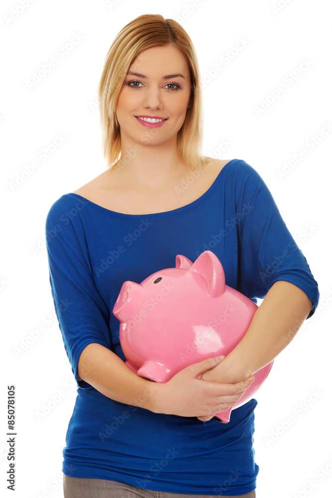 Happy woman holding piggybank. Happy woman holding piggybank.