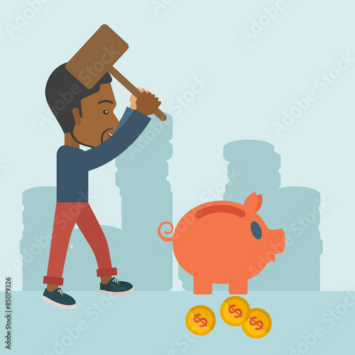 Black guy holding a hammer breaking piggy bank.