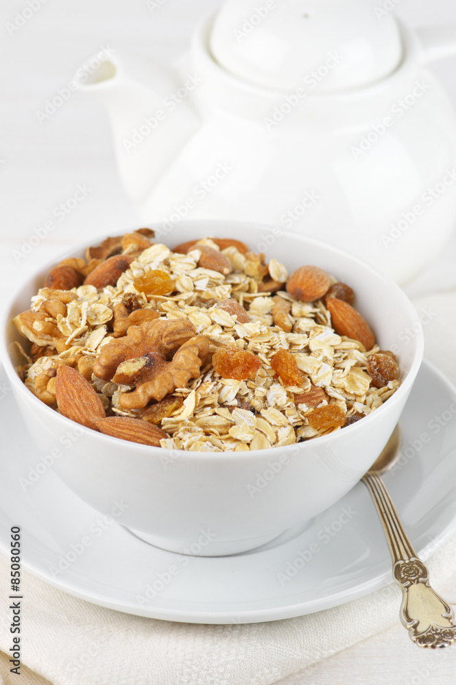 Oatmeal flakes with nuts in bowl Oatmeal flakes with nuts in bowl