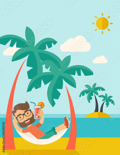 Young man on th beach relaxing and drinking cocktail.