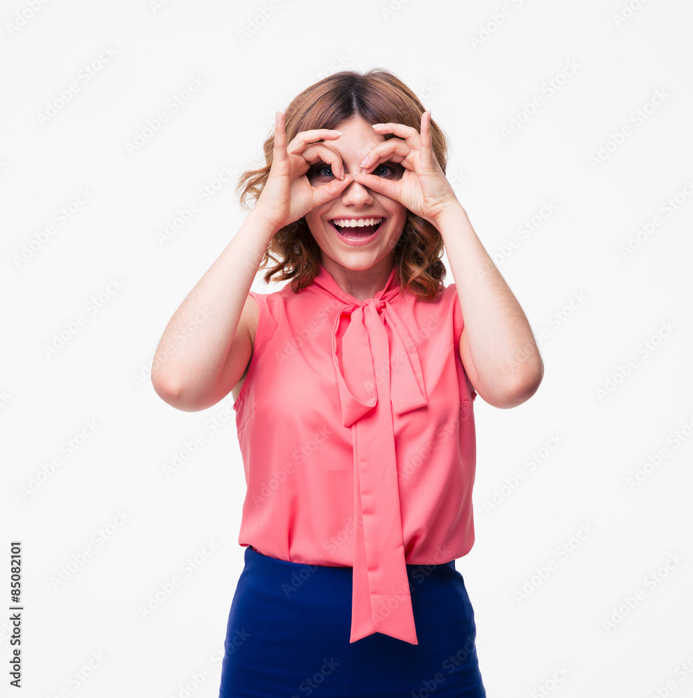Casual woman looking at camera through fingers Casual woman looking at camera through fingers
