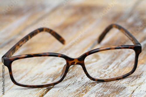 Reading glasses on rustic wooden surface 