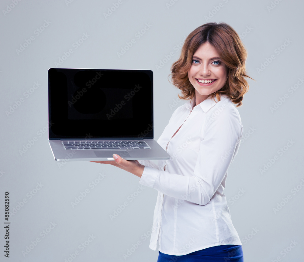 Happy businesswoman showing laptop screen Happy businesswoman showing laptop screen