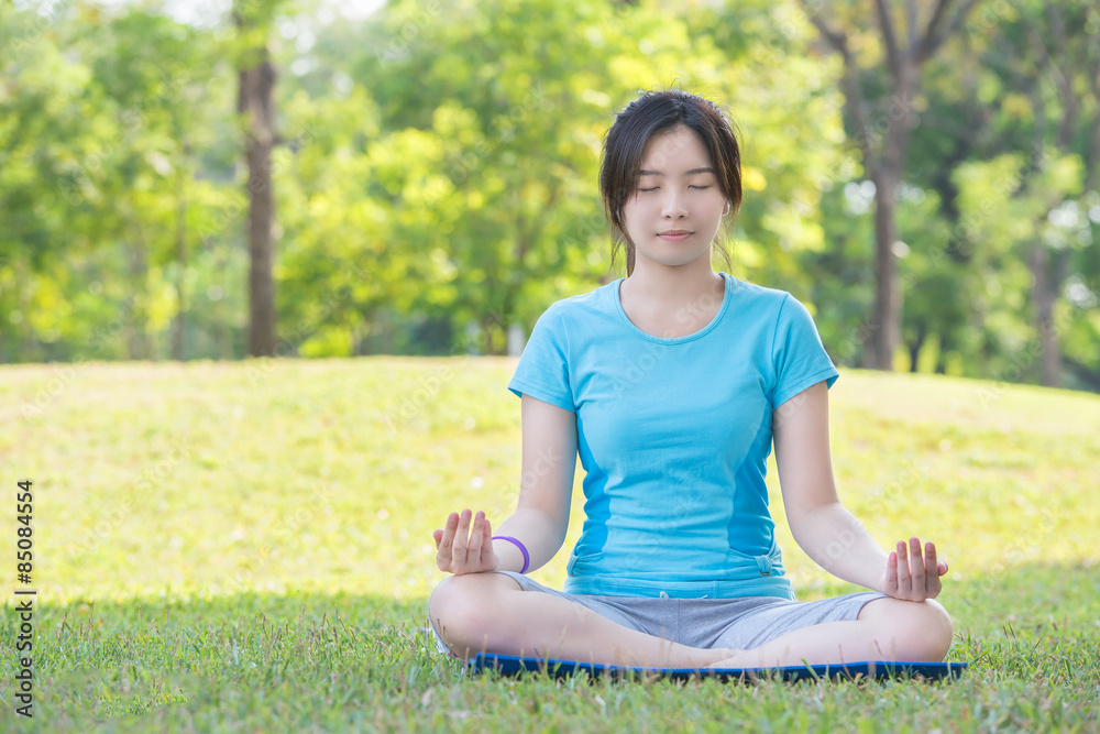Asian girl making yoga call Easy Pose in park Asian girl making yoga call Easy Pose in park