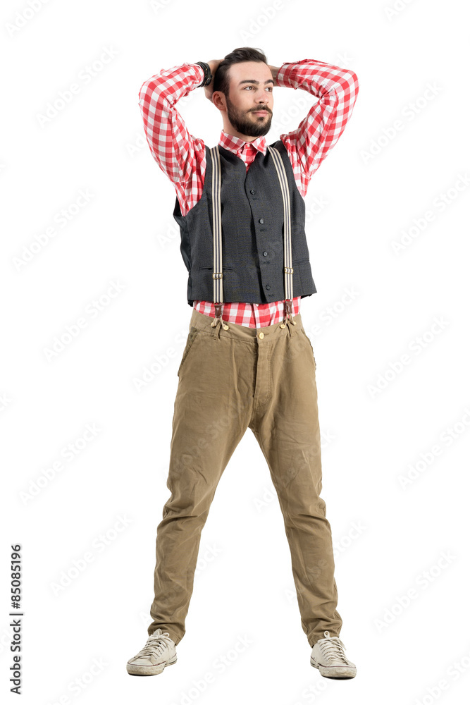 Fototapeta premium Young bearded man adjusting hair with his hands isolated