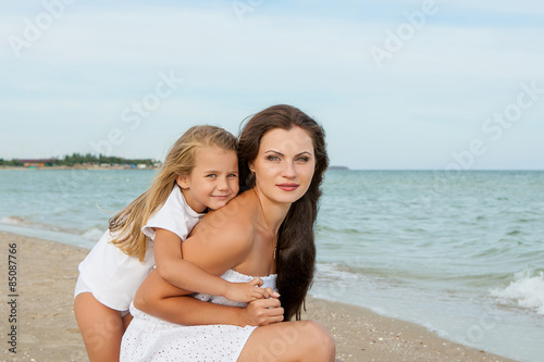 Happy beautiful mother and daughter enjoying beach time © Malsveta
