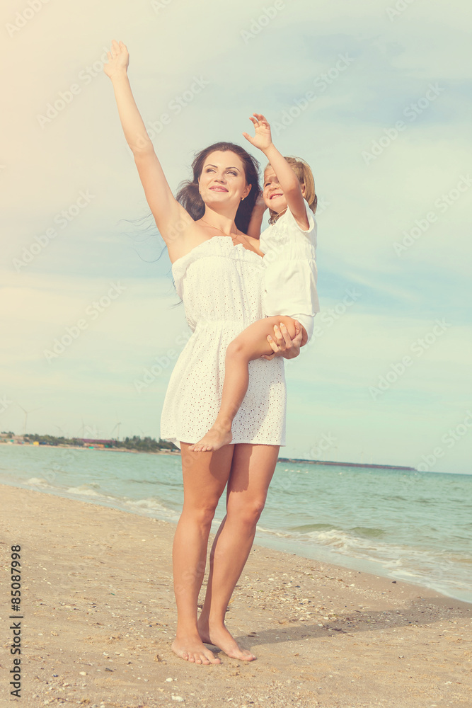Happy beautiful mother and daughter enjoying beach time Happy beautiful mother and daughter enjoying beach time