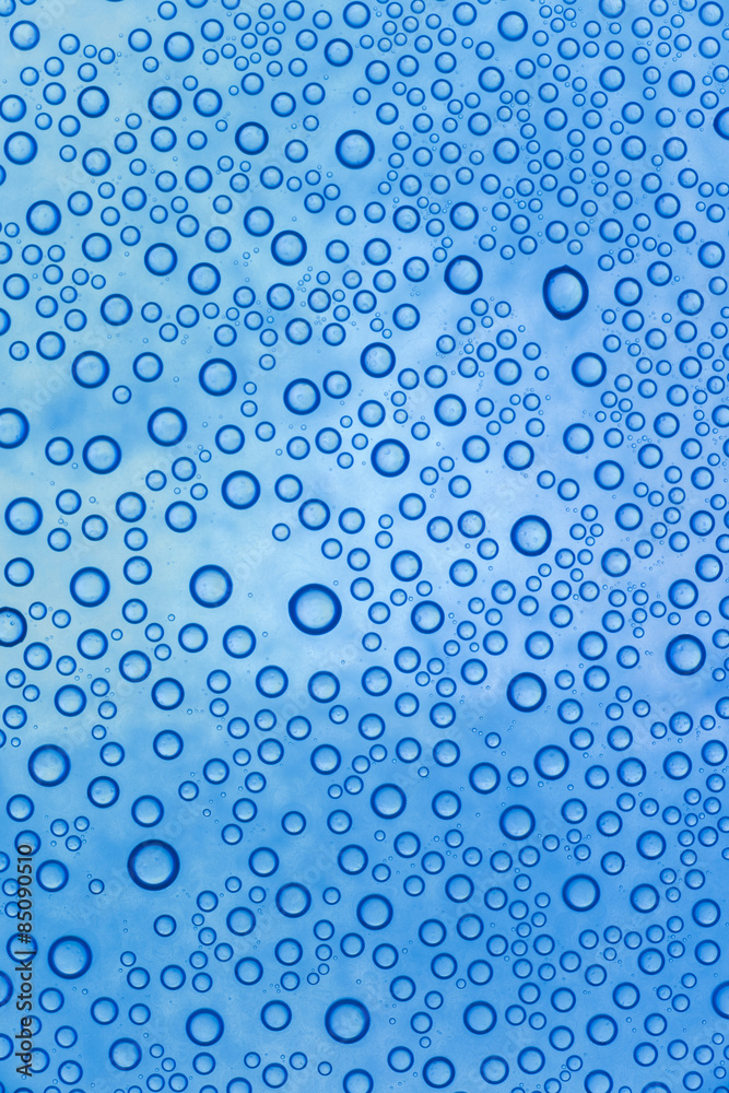 blue waterdrops on glass surface