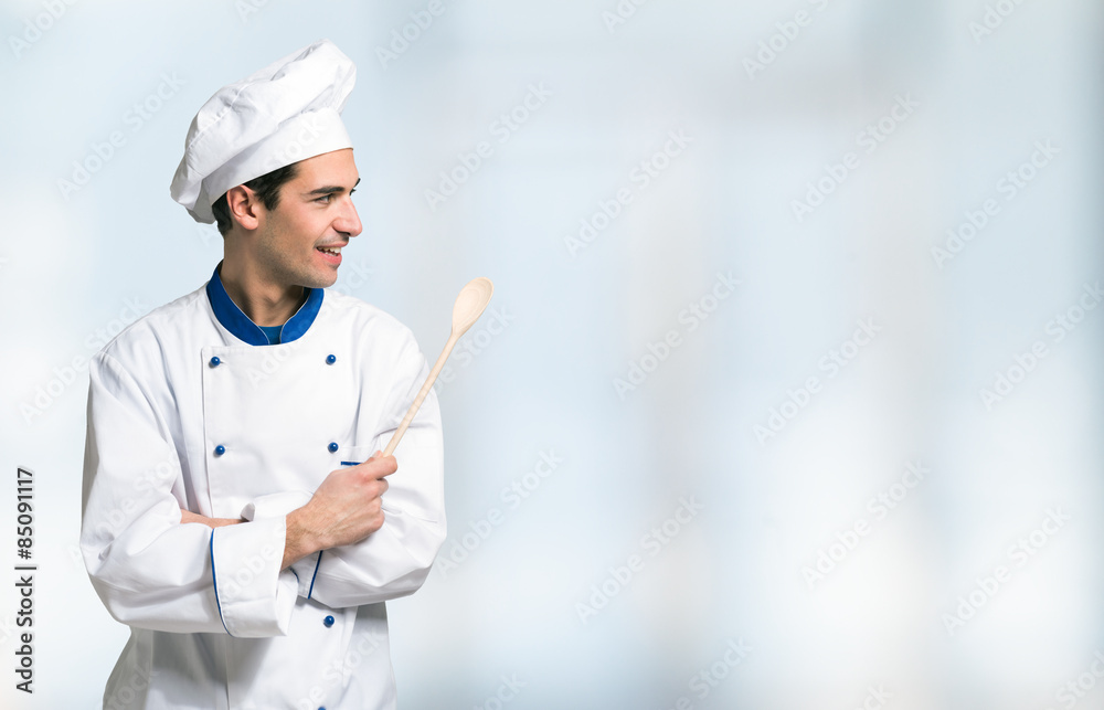 Smiling chef in front of a bright background Smiling chef in front of a bright background