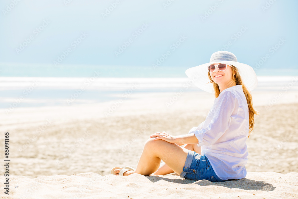 Beautifil young woman sitting on the beach at sunny day enjoing Beautifil young woman sitting on the beach at sunny day enjoing