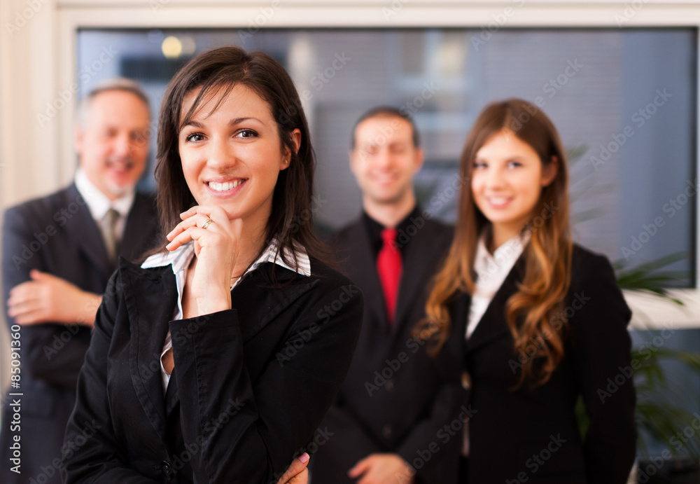 Smiling businesswoman in front of her colleagues Smiling businesswoman in front of her colleagues