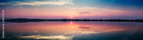 Perfectly specular reflection on the salt pans at sunset - panoramic view