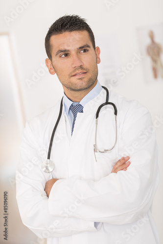 portrait of handsome young doctor in office