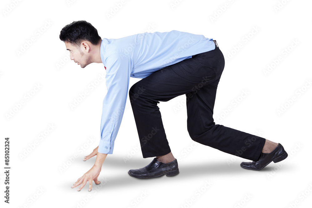 Young entrepreneur in ready position to run Young entrepreneur in ready position to run