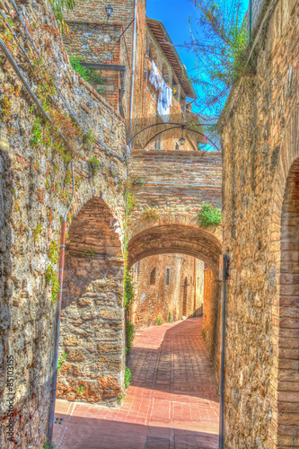 arches in a narrow street in San Gimignano