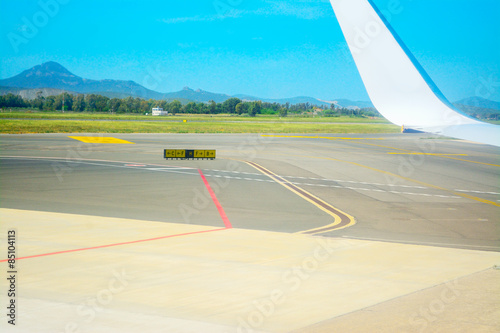 taxiway signs and airplane wing