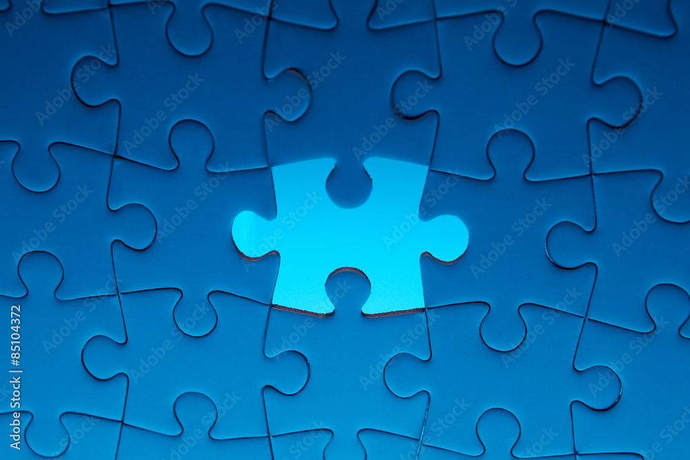 Missing jigsaw puzzle piece with light glow Missing jigsaw puzzle piece with light glow